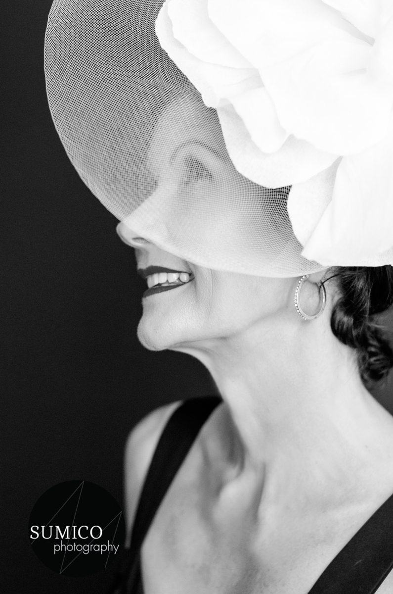 Lady with a white fascinator by Sumico Photography